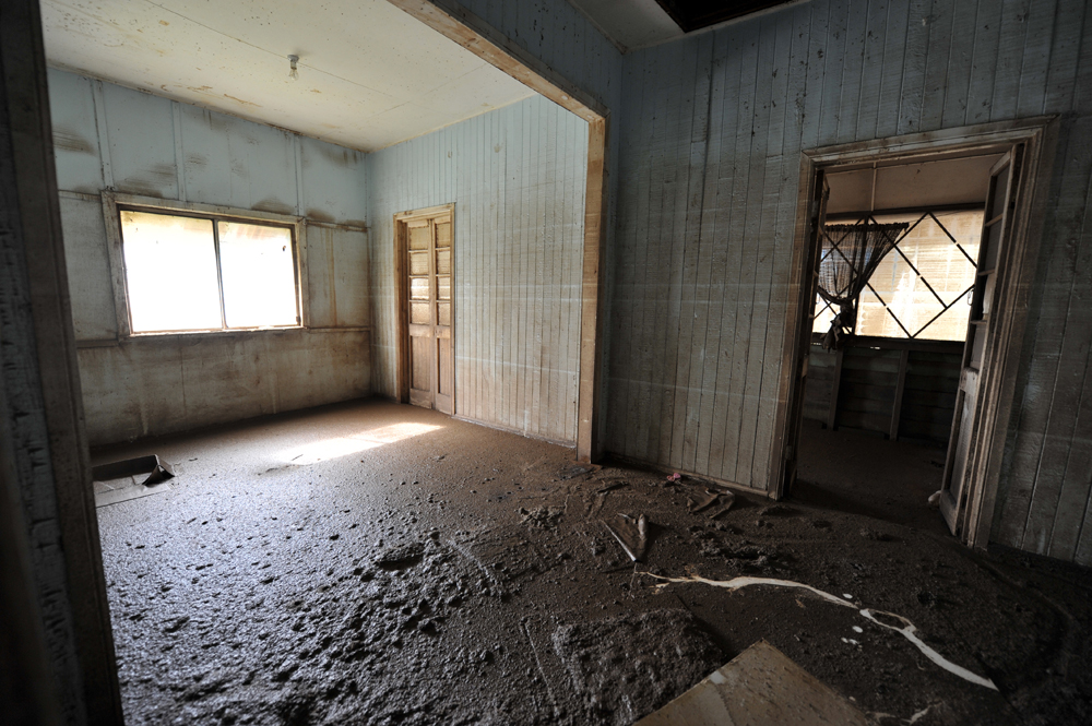 Thick mud covers the interior of a house from floor to ceiling in Goodna, Queensland.