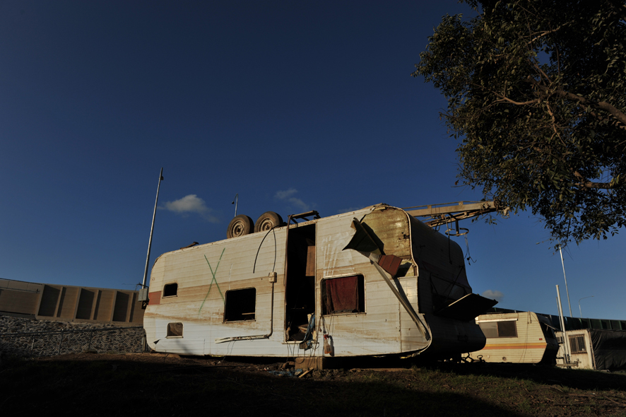 A caravan is overturned during the floods at Goodna, Queensland.