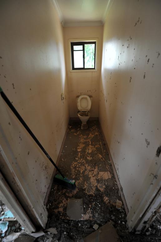 A toilet awaits it's turn to be stripped of gyprock in a house in North Booval, Queensland.